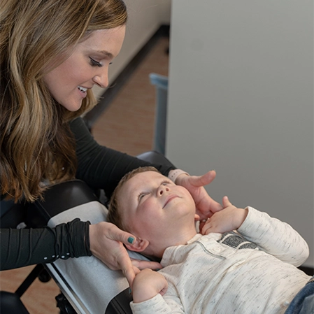 Chiropractor Columbia MO Chelsey Aitken Adjusting Pediatric Patient